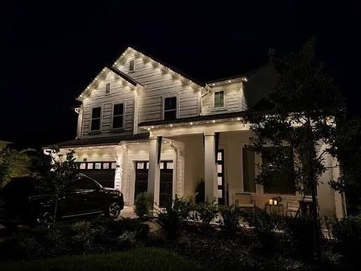 Dark farmhouse-style home with crisp warm-white roofline lighting